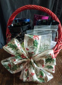 The supplies needed to make an herb garden advent calendar in a gift basket.