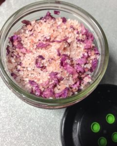 Pink Himalayan sea salt and rose petals in a jar.