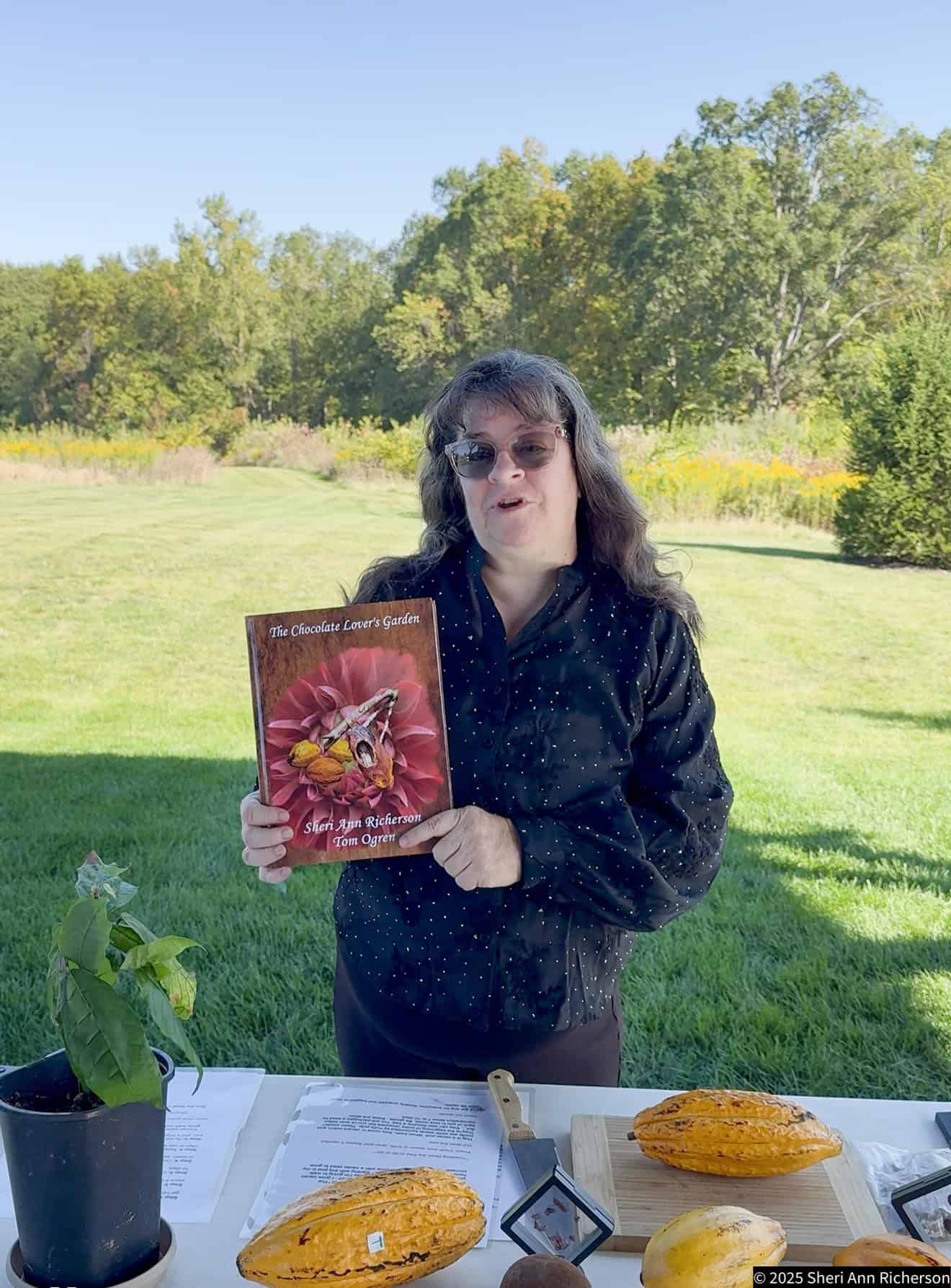 Sheri Ann Richerson holding The Chocolate Lover's Garden during a chocolate gardening presentation