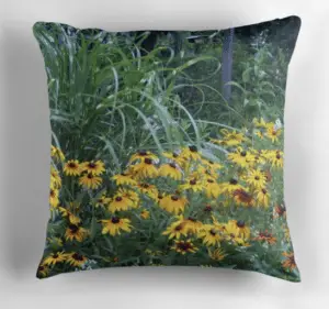 Ornamental grass and black eyed Susans in a landscape on a pillow.